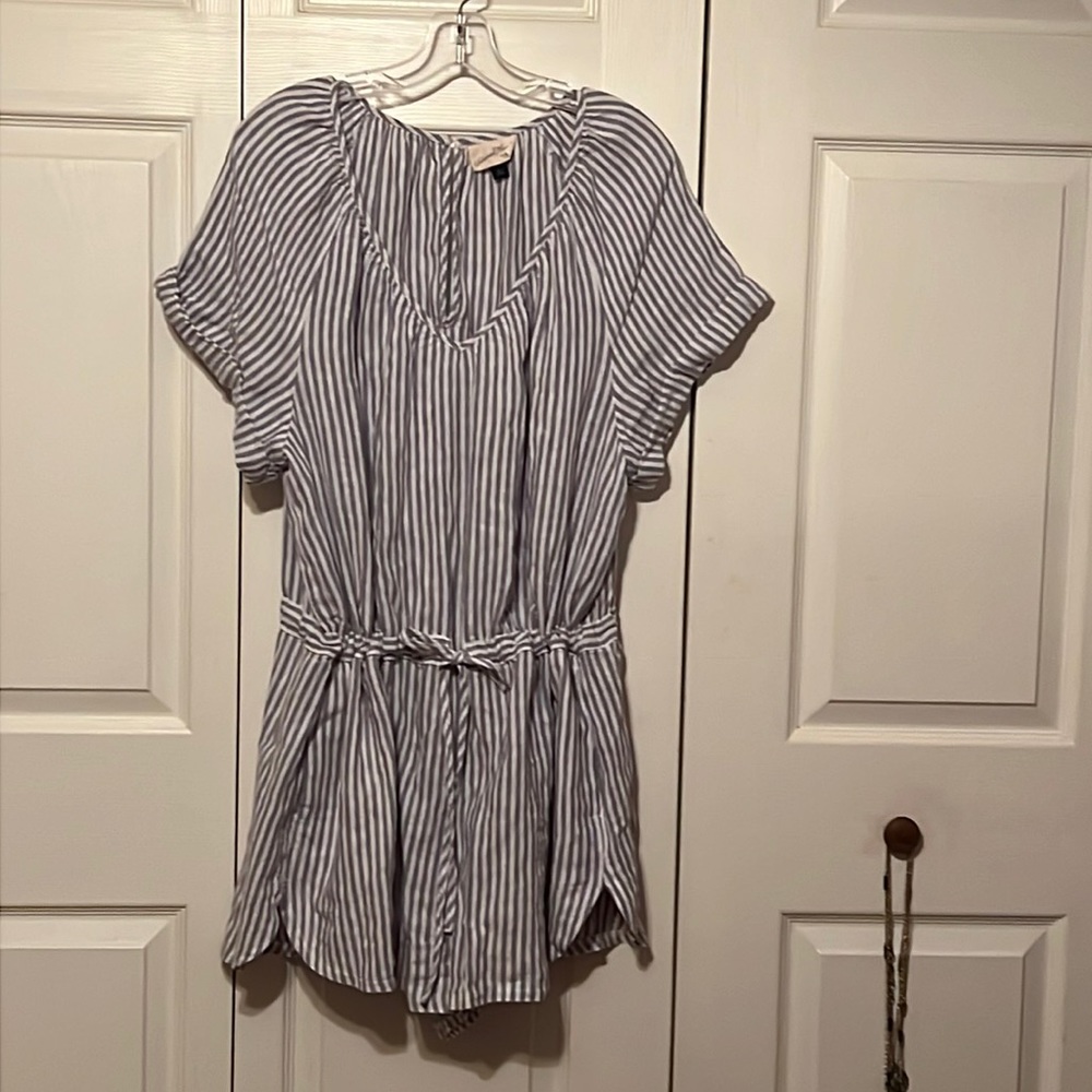 V neck, one piece clothing.